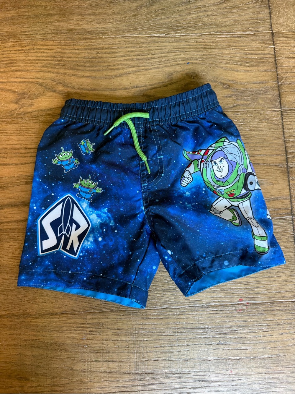 Disney Buzz Lightyear Blue Galactic Swim Trunks with Green Drawstring